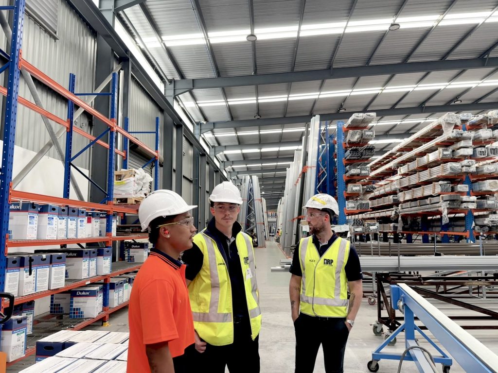 IRP consultants in branded hi-vis walking a client warehouse
