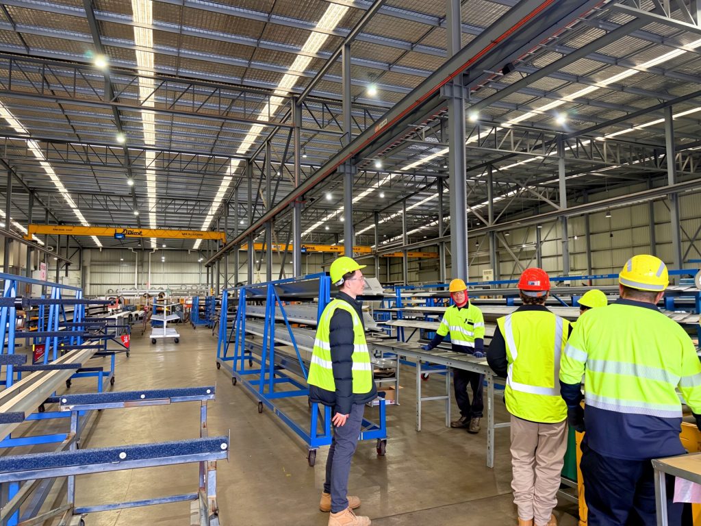 IRP consultants and client staff talking around a workbench on the factory floor